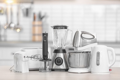 Photo of Different modern kitchen appliances on table indoors. Interior element