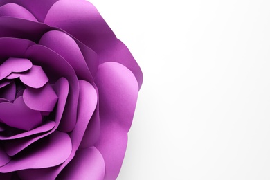 Photo of Beautiful purple flower made of paper on white background, top view