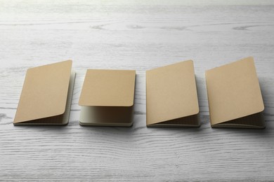 Photo of Modern kraft planners on white wooden table