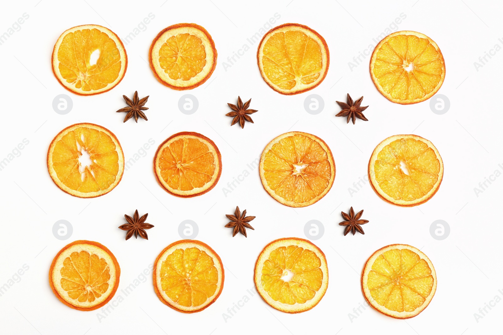 Photo of Flat lay composition with dry orange slices and anise stars on white background