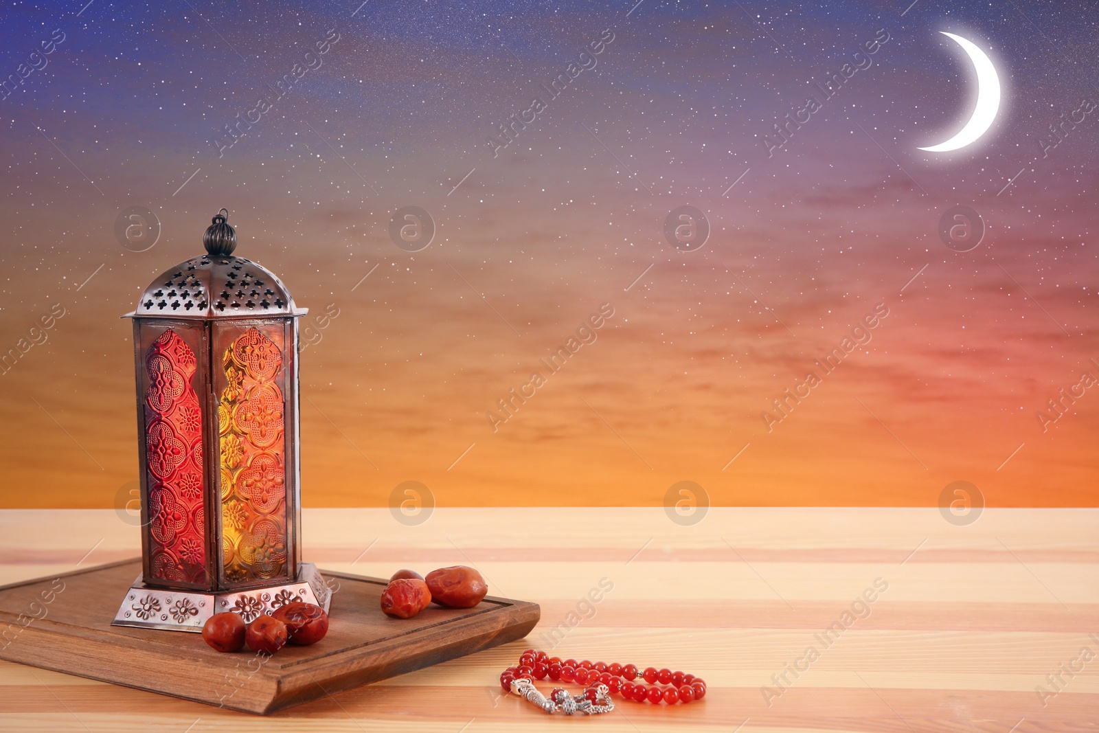 Image of Traditional Ramadan lantern, dates and prayer beads on table. Muslim holiday