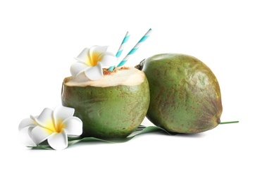 Photo of Fresh green coconuts with drinking straws and flowers on white background