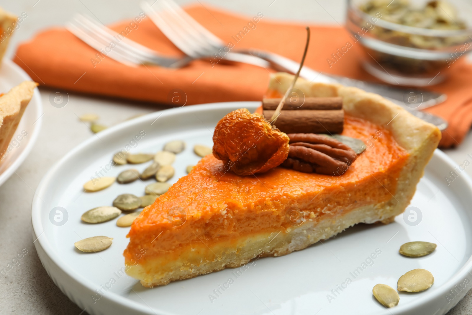 Photo of Slice of delicious homemade pumpkin pie on plate, closeup