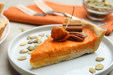 Slice of delicious homemade pumpkin pie on plate, closeup