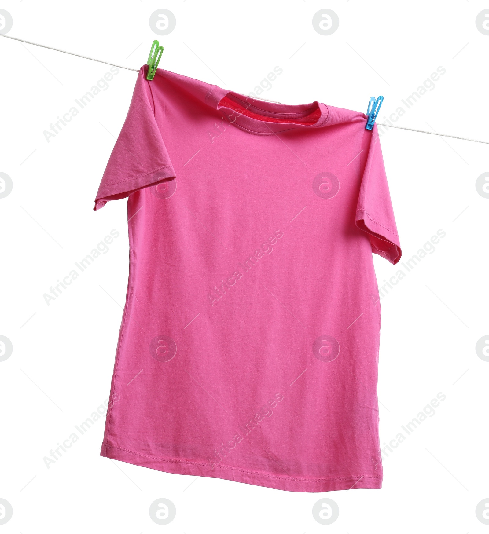 Photo of Pink t-shirt drying on washing line against white background