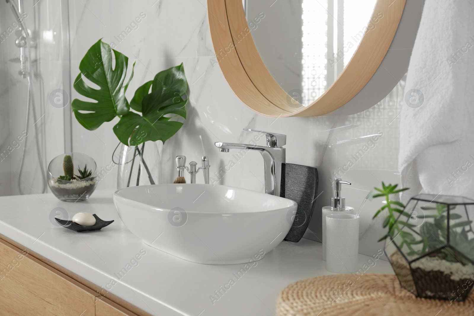 Photo of Stylish bathroom interior with vessel sink and decor elements