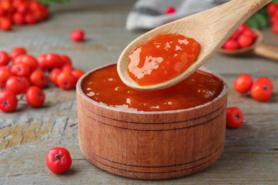 Delicious rowan jam in wooden bowl on table, closeup