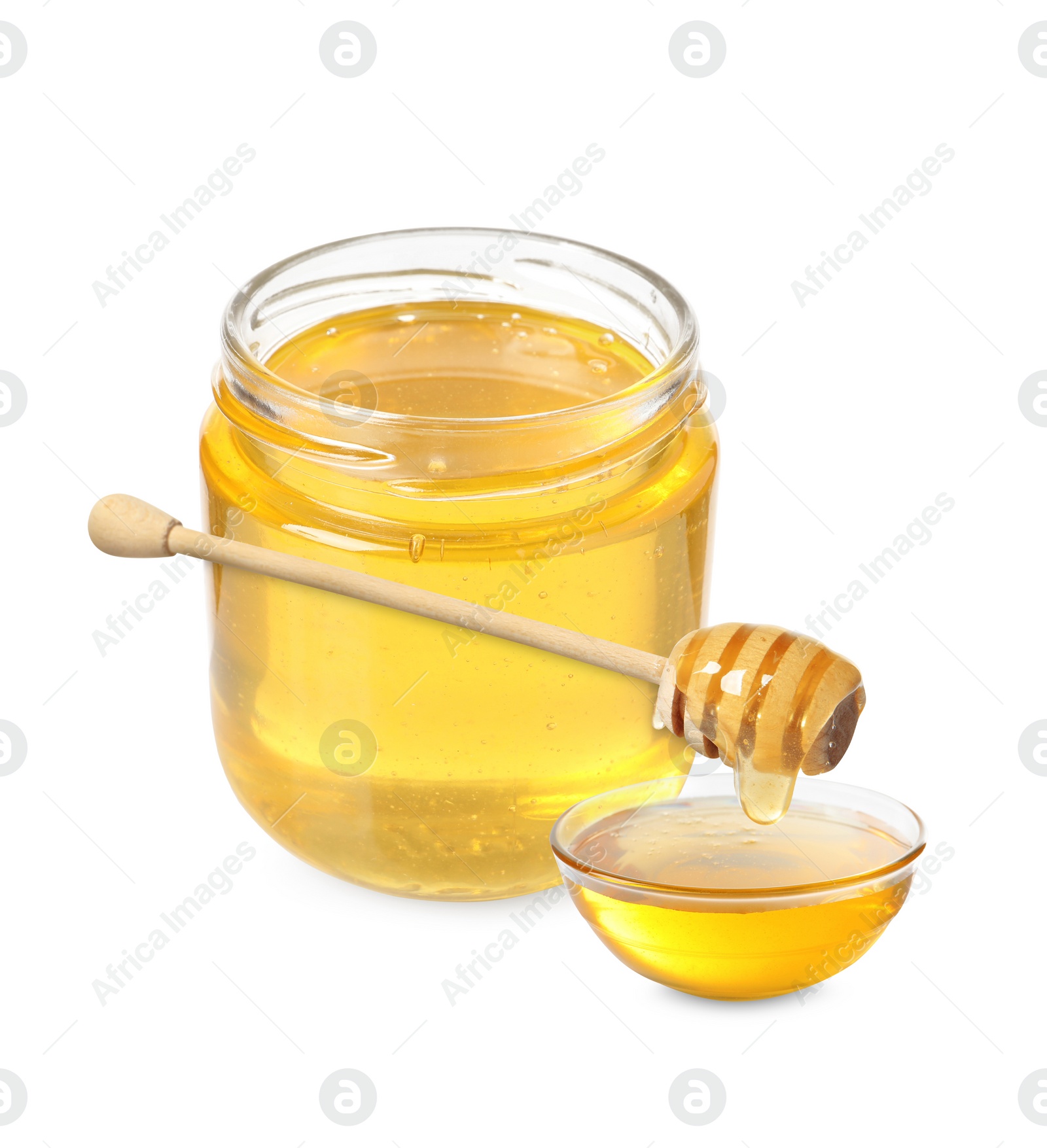 Image of Natural honey dripping from dipper into glass bowl. Jar full of honey on white background