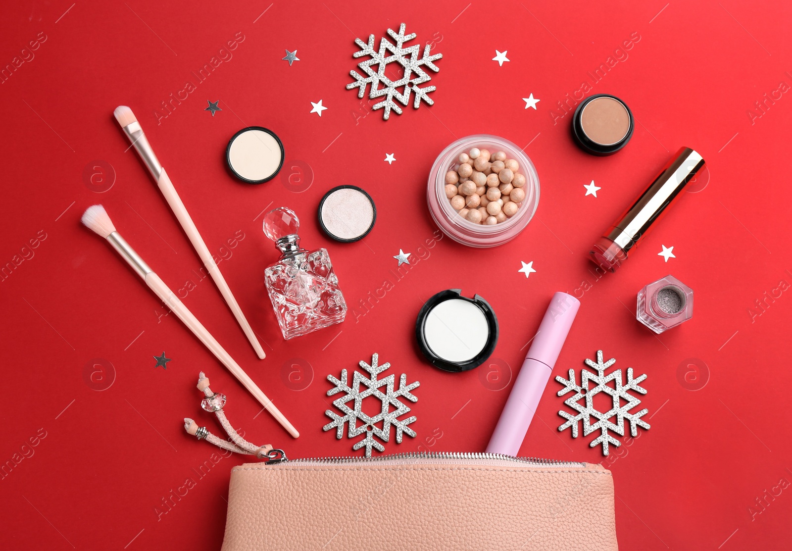 Photo of Flat lay composition with decorative cosmetic products on red background. Winter care