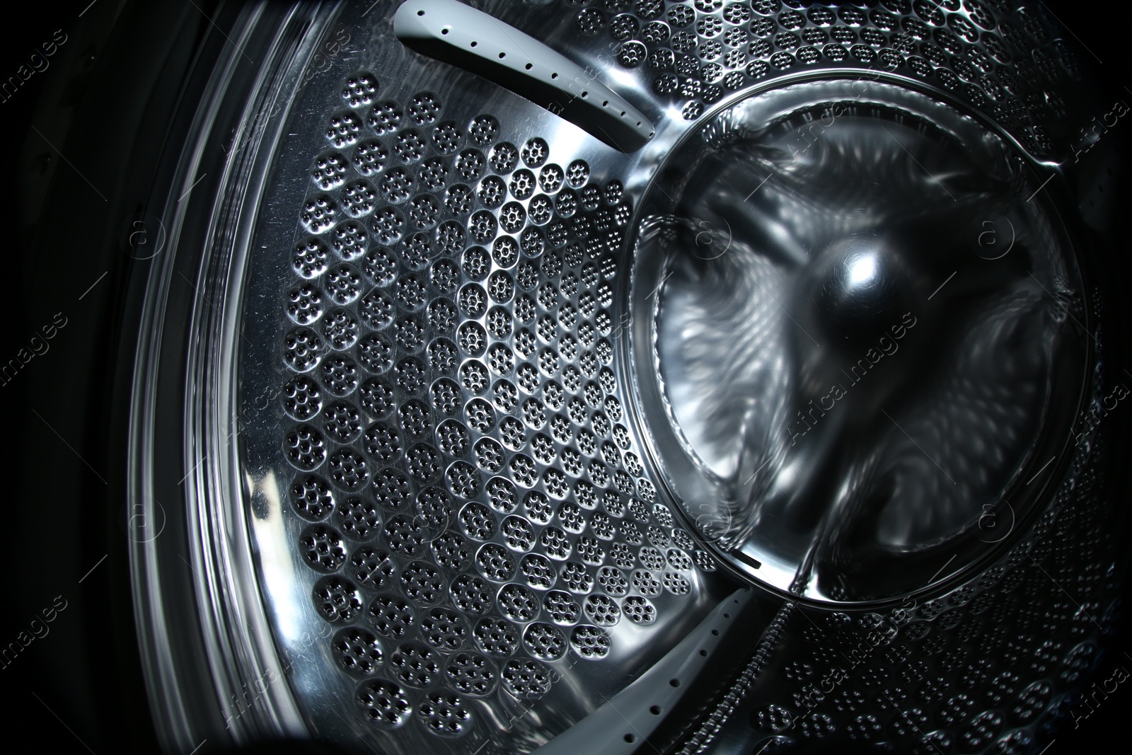 Photo of Empty washing machine drum, closeup. Laundry day