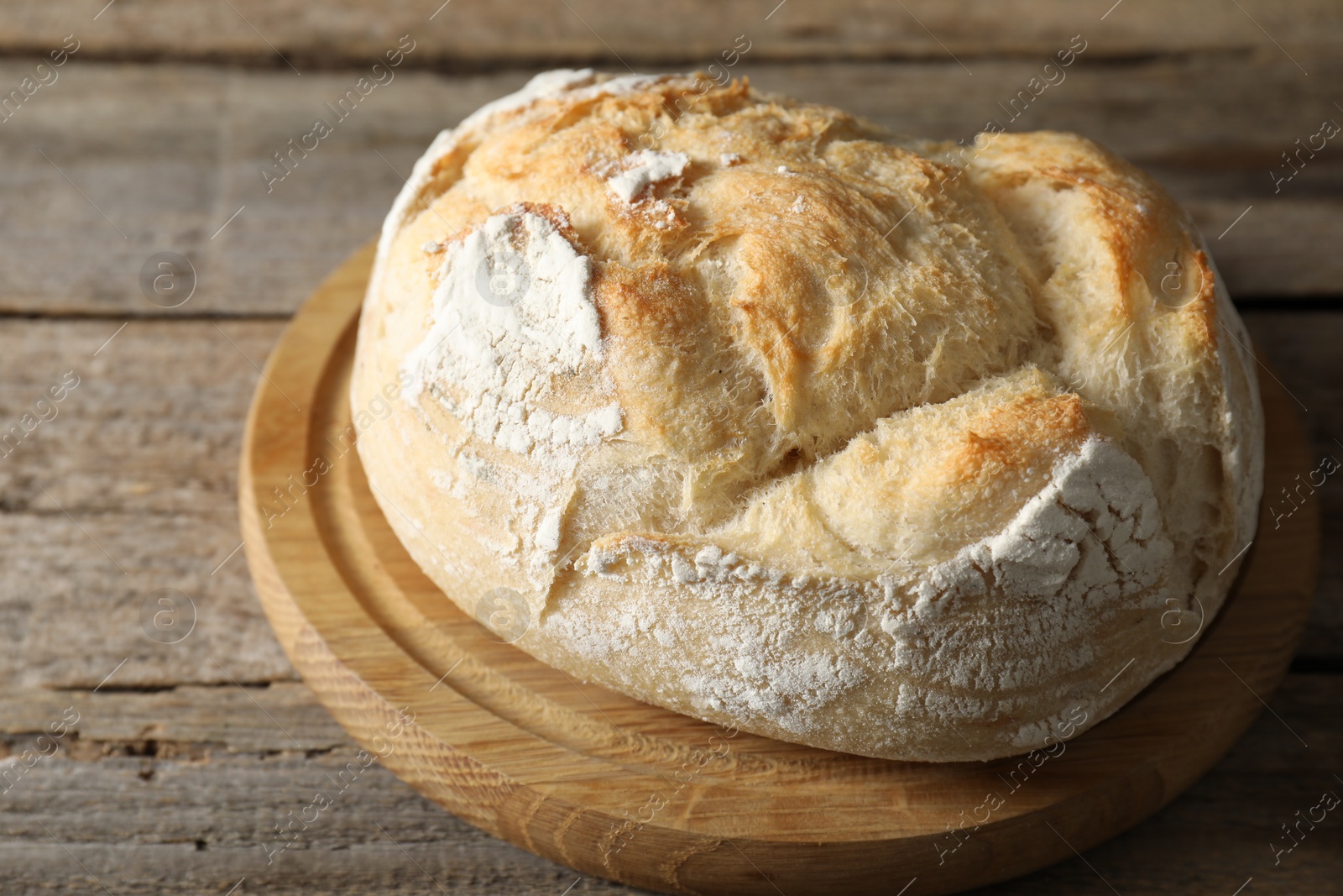 Photo of Freshly baked sourdough bread on wooden table