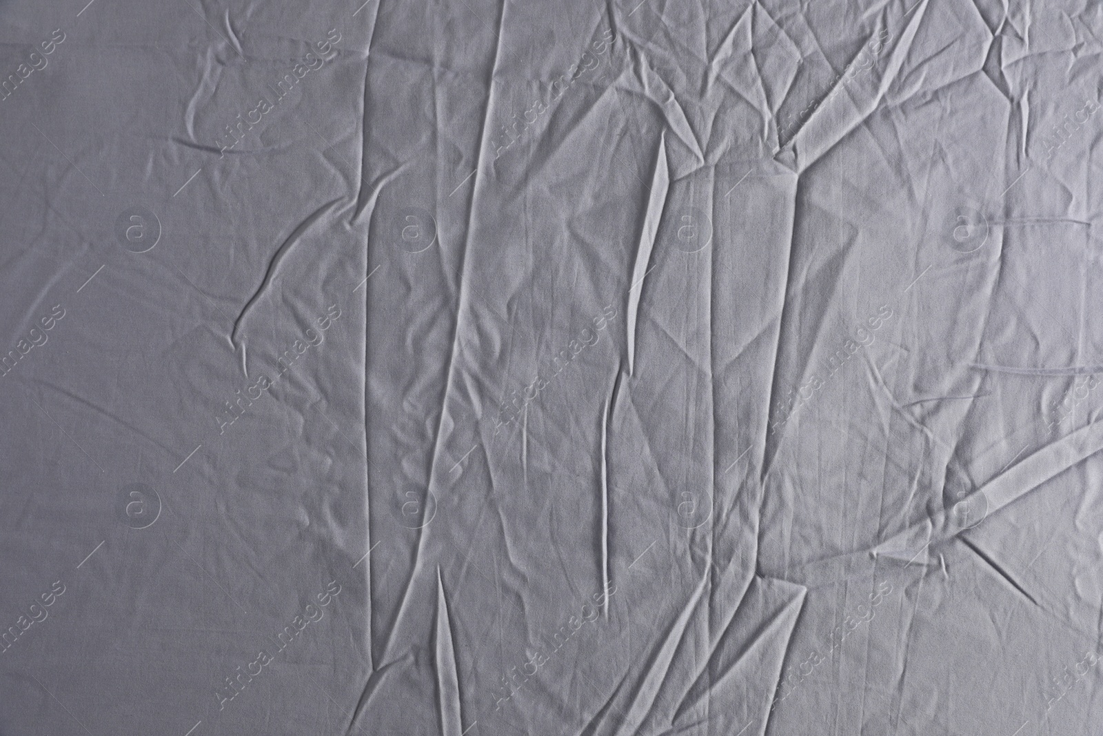 Photo of Crumpled grey fabric as background, top view