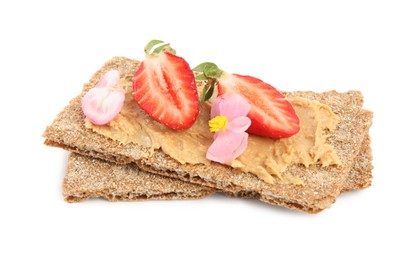Photo of Fresh rye crispbreads with peanut butter, strawberry and flowers on white background