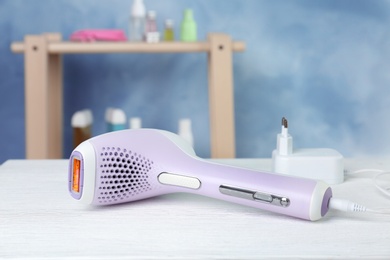 Photo of Modern laser epilator on table