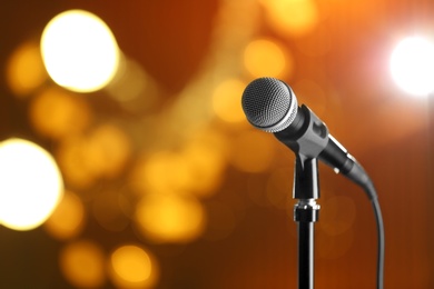 Photo of Microphone against festive lights, space for text