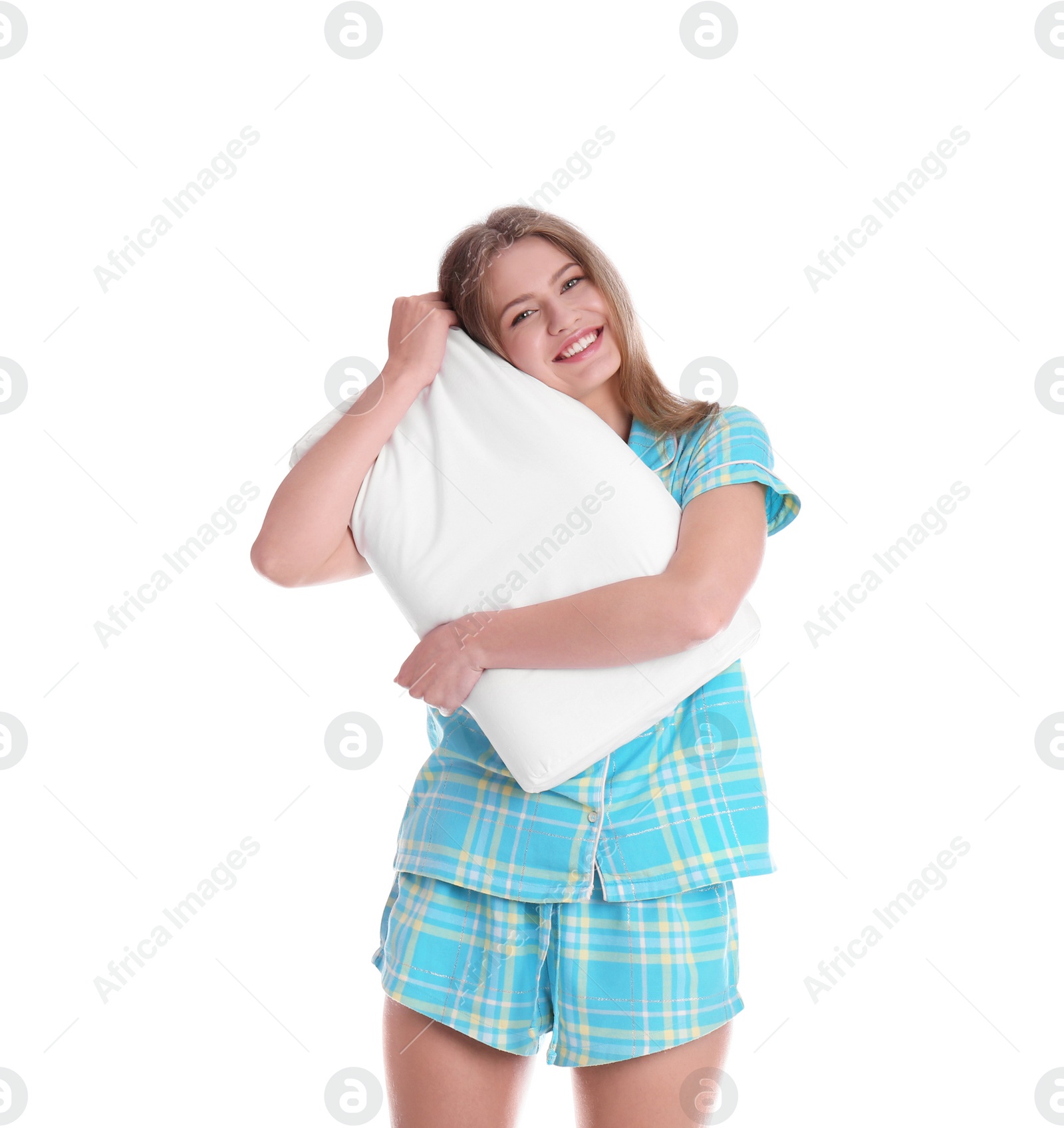 Photo of Young woman in pajamas embracing pillow on white background
