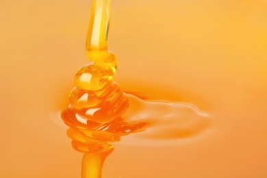 Pouring fresh sweet honey, closeup