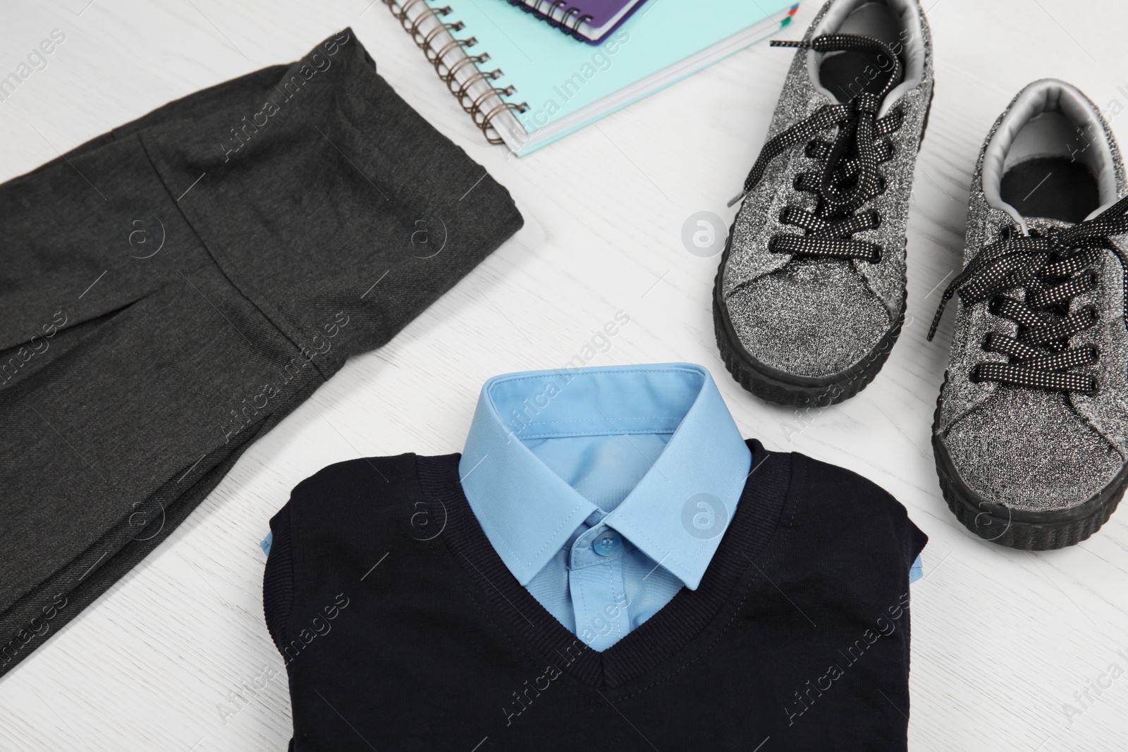 Photo of School uniform for girl on white wooden background