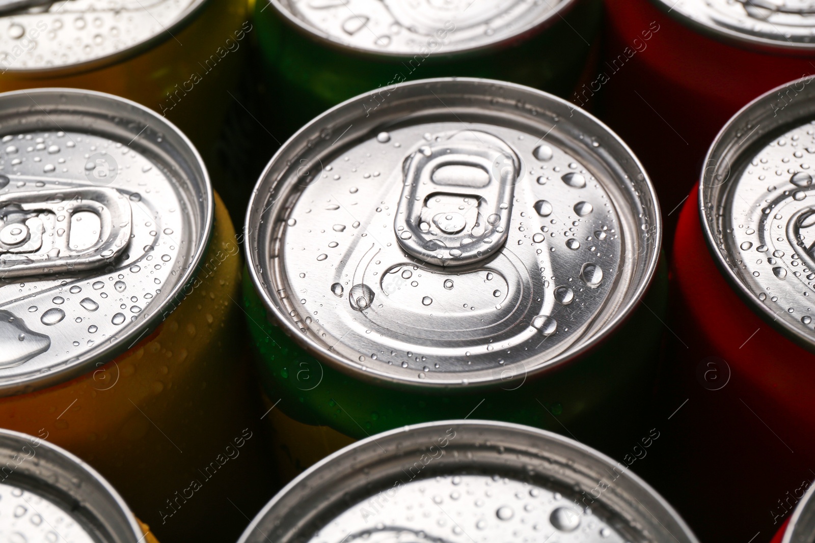 Photo of Energy drinks in wet cans, closeup. Functional beverage