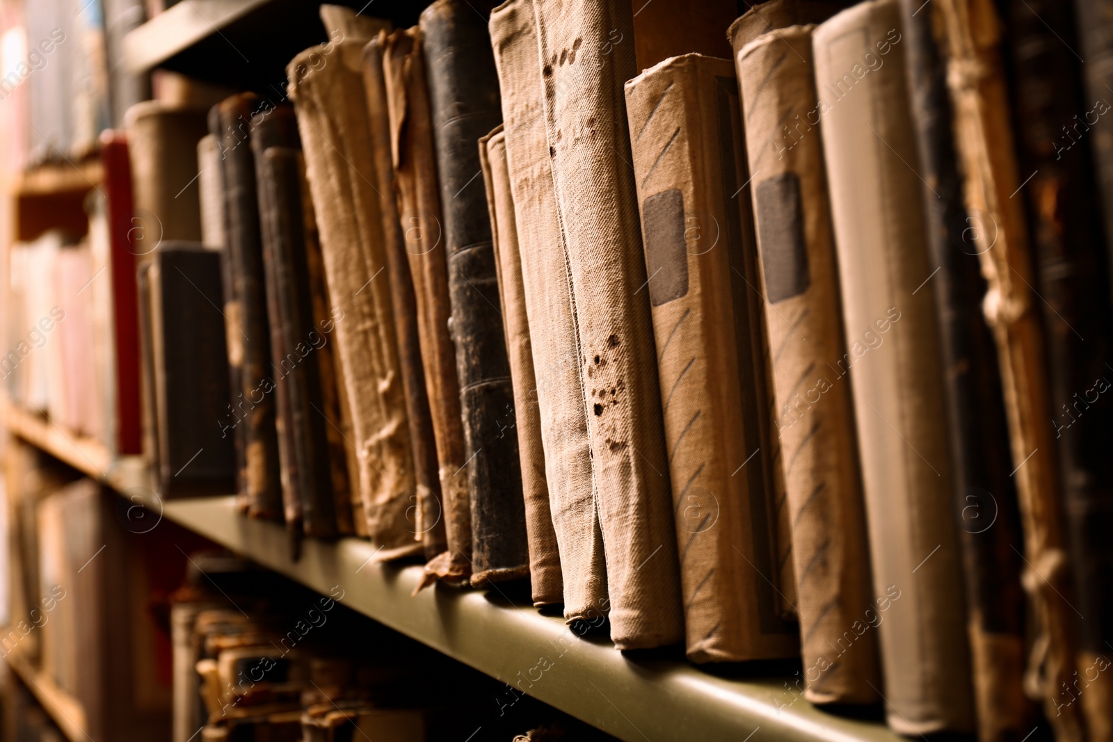 Image of Old books on shelf in library, closeup