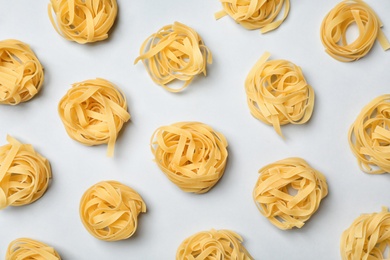 Photo of Flat lay composition with raw pasta on white background