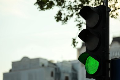 View of traffic light in city, space for text