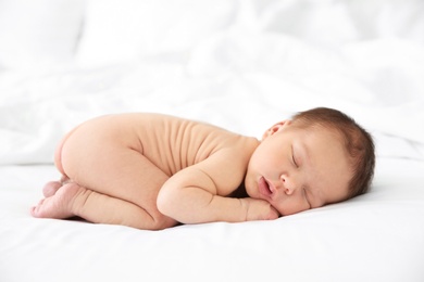 Photo of Adorable newborn baby sleeping on bed