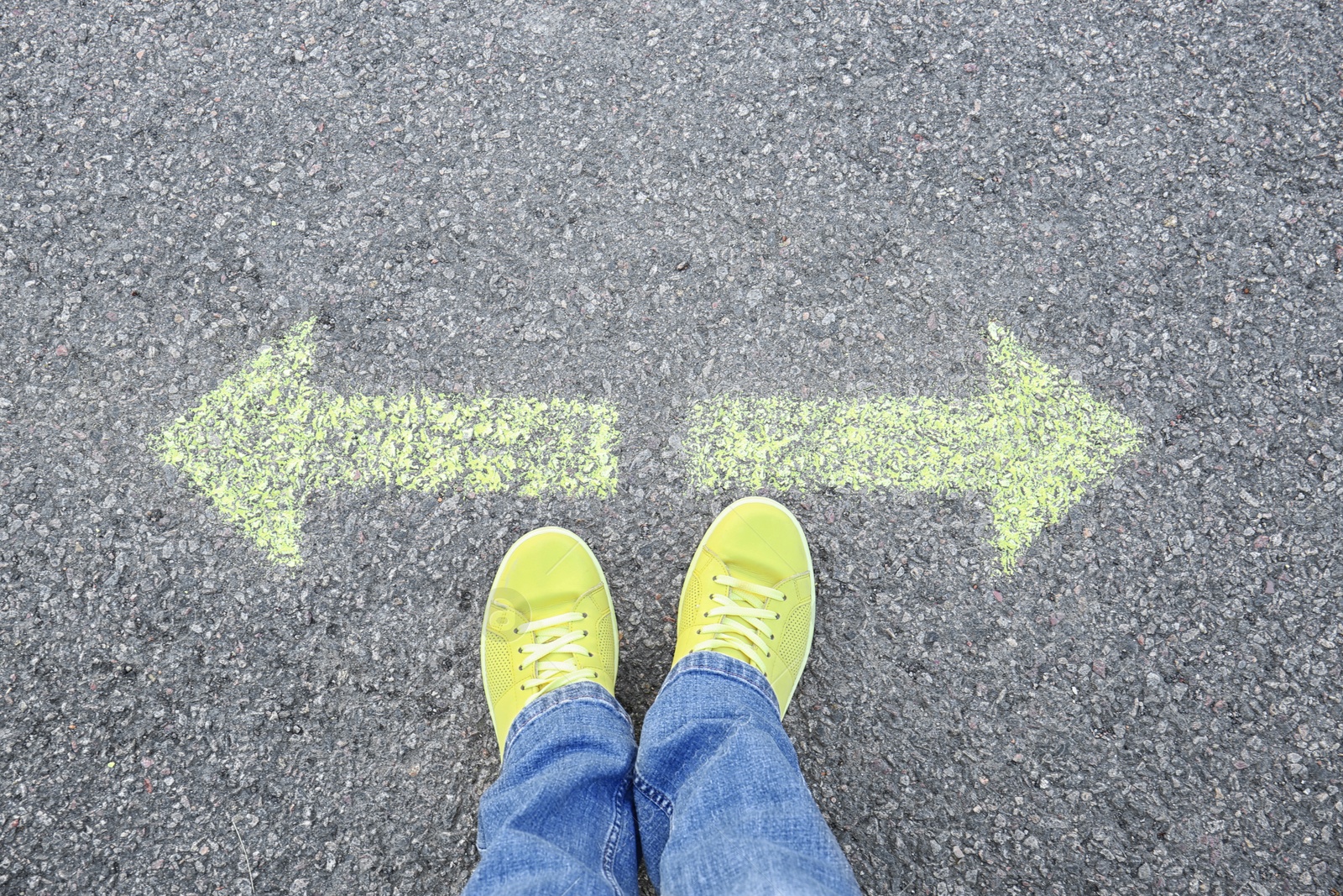 Photo of Woman standing on road near arrows marking, closeup