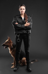 Female security guard with dog on dark background