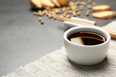 Bowl of soy sauce on table. Space for text