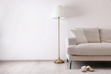 Photo of Interior of living room with comfortable sofa and floor lamp
