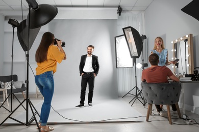 Professional team working with model in photo studio