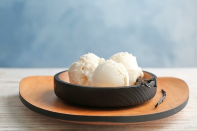 Photo of Plate with tasty vanilla ice cream on table