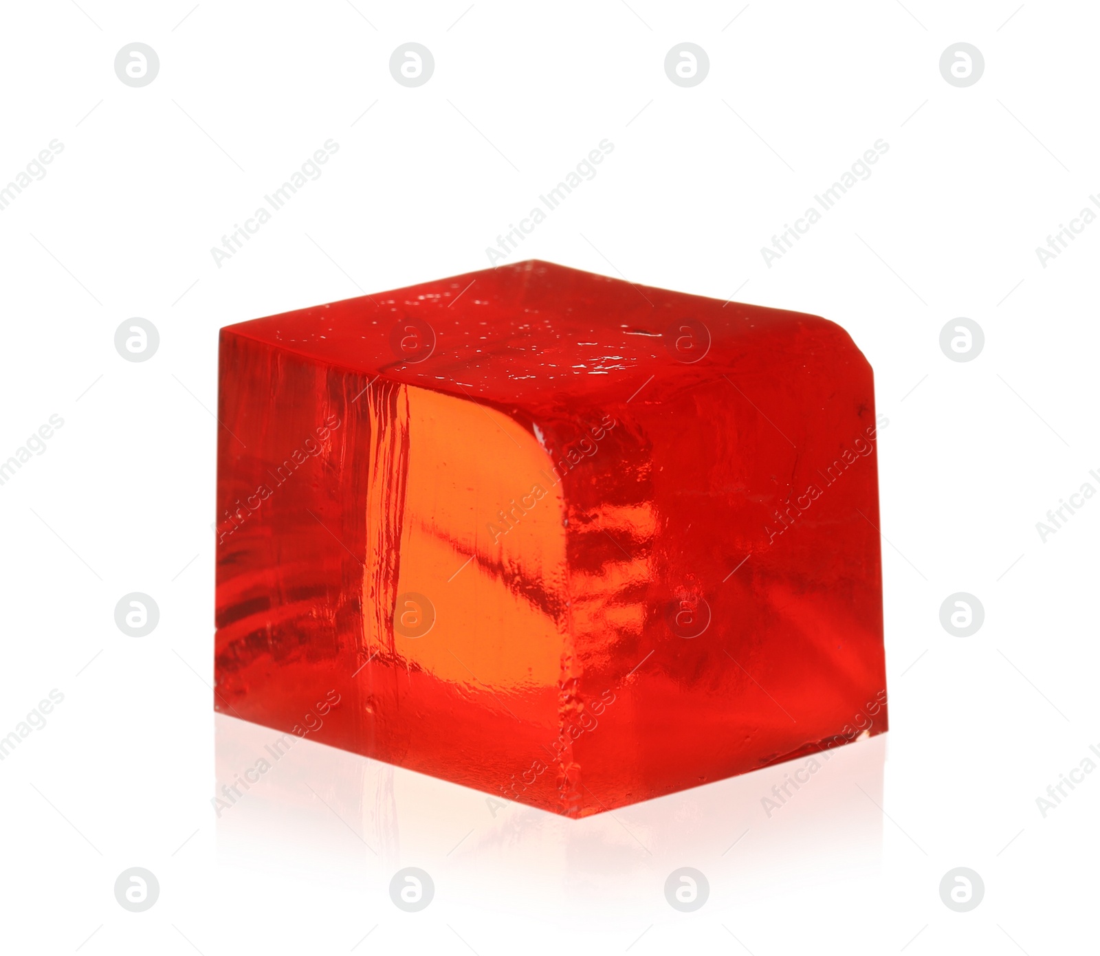 Photo of Delicious red jelly cube on white background