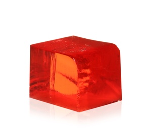 Delicious red jelly cube on white background