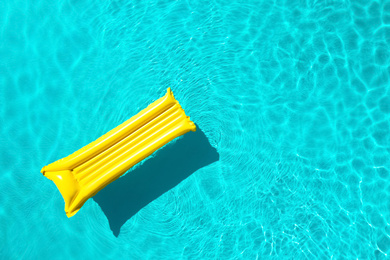 Image of Inflatable mattress floating in swimming pool, top view with space for text. Summer vacation