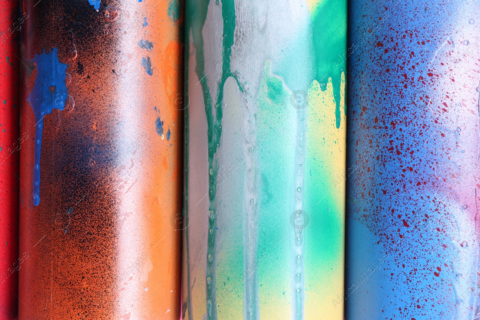 Photo of Different spray paint cans as background, top view