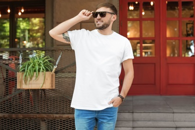 Young man wearing white t-shirt on street