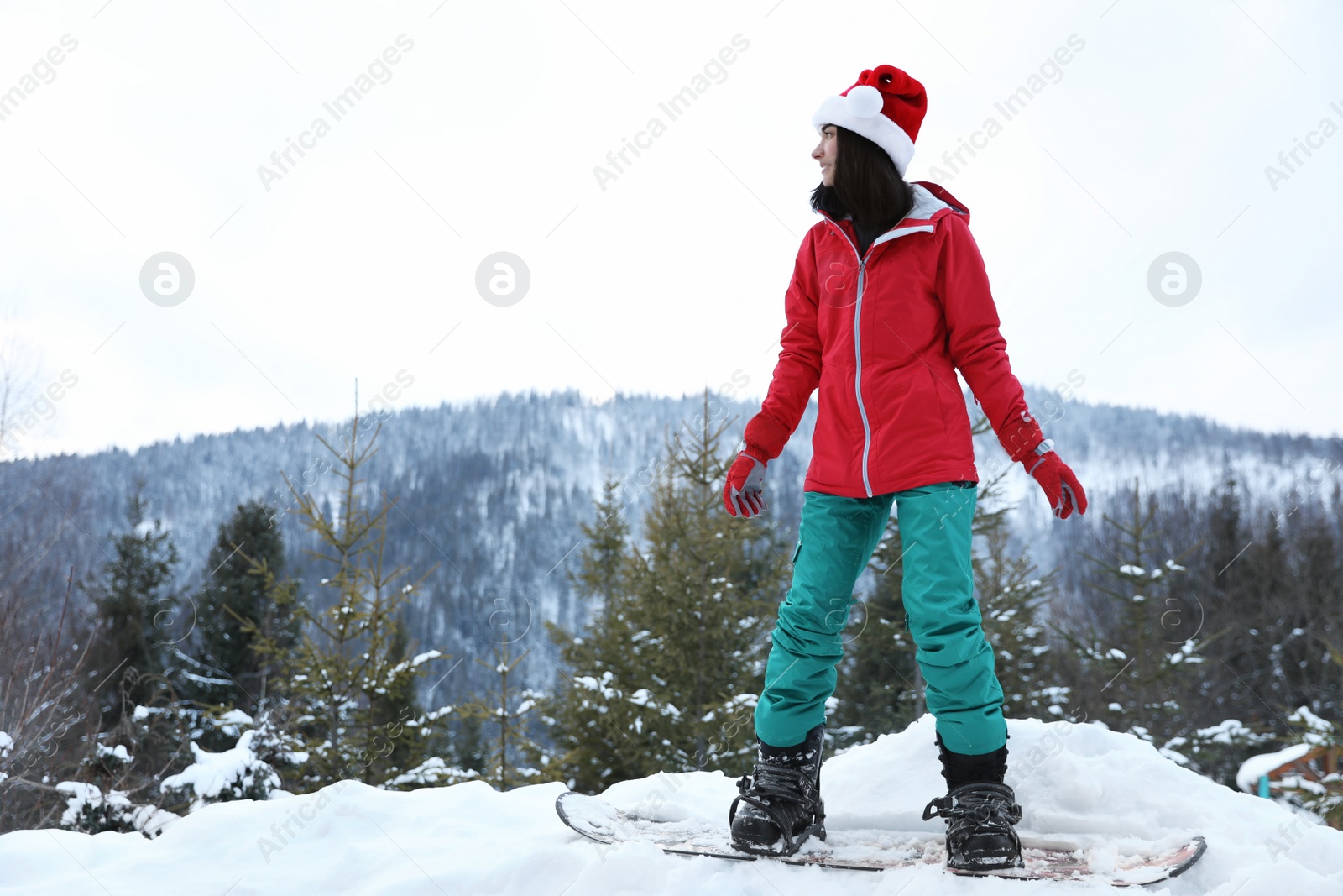 Photo of Young snowboarder wearing winter sport clothes on hill