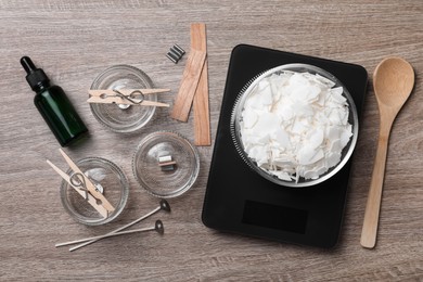 Photo of Flat lay composition with ingredients for homemade candles on wooden background