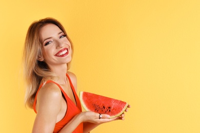 Photo of Pretty young woman with juicy watermelon on color background