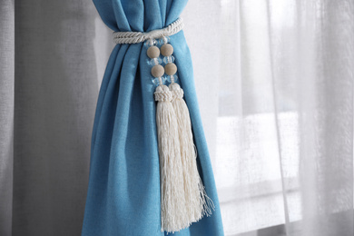 Photo of Window curtains with tassel tieback, closeup view