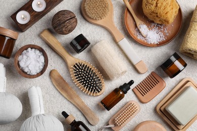 Flat lay composition with different spa products on light grey textured table