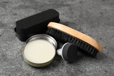 Composition with shoe care accessories on grey background, closeup