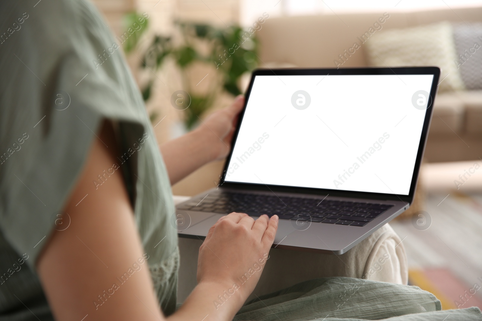 Photo of Woman using laptop at home, closeup. Space for design