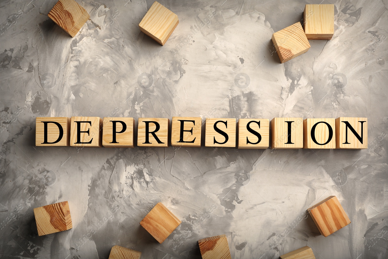 Photo of Wooden cubes with word DEPRESSION on grunge background, flat lay