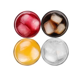 Glasses of different refreshing soda water with ice cubes isolated on white, top view