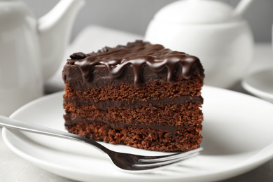 Photo of Tasty chocolate cake served on white table, closeup