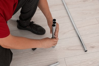 Worker installing new metal pipes indoors, closeup