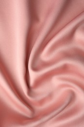 Photo of Crumpled pink silk fabric as background, top view